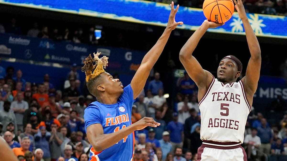 Texas A&amp;amp;M guard Hassan Diarra (5) makes the game-winning shot over Florida guard Kowacie Reeves (14) during overtime of an NCAA college basketball game at the Southeastern Conference tournament in Tampa, Fla., Thursday, March 10, 2022.