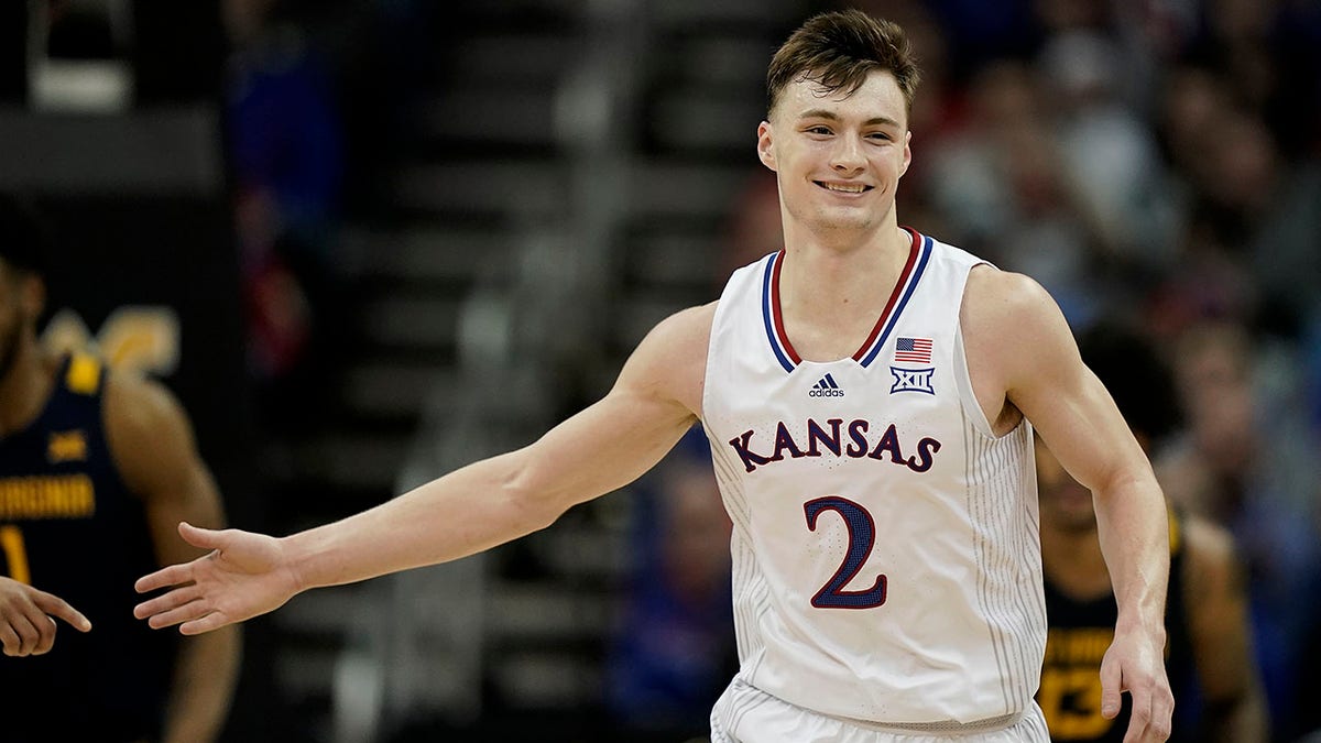Kansas guard Christian Braun celebrates after a basket during the first half of an NCAA college basketball game against West Virginia in the quarterfinal round of the Big 12 Conference tournament in Kansas City, Mo., Thursday, March 10, 2022.