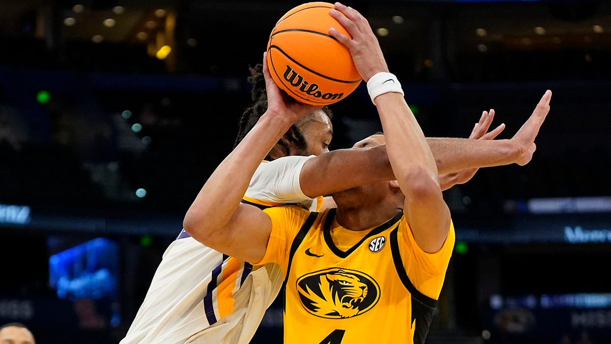 LSU center Efton Reid, left, fouls Missouri guard Javon Pickett (4) as he goes up for a shot during the second half of an NCAA men's college basketball game at the Southeastern Conference tournament in Tampa, Fla., Thursday, March 10, 2022.