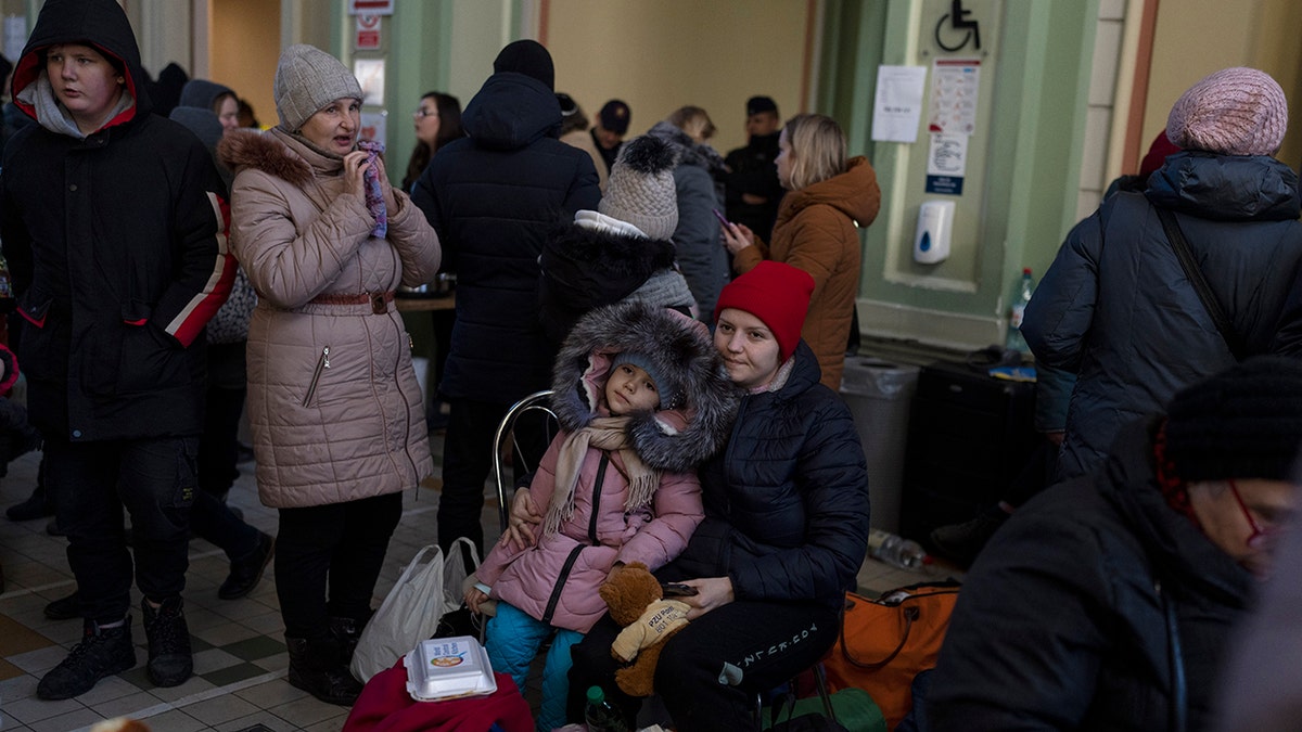 Ukrainian refugees wait at Przemysl train station, southeastern Poland, on Friday, March 11, 2022. Thousands of people have been killed and more than 2.3 million have fled the country since Russian troops crossed into Ukraine on Feb. 24.