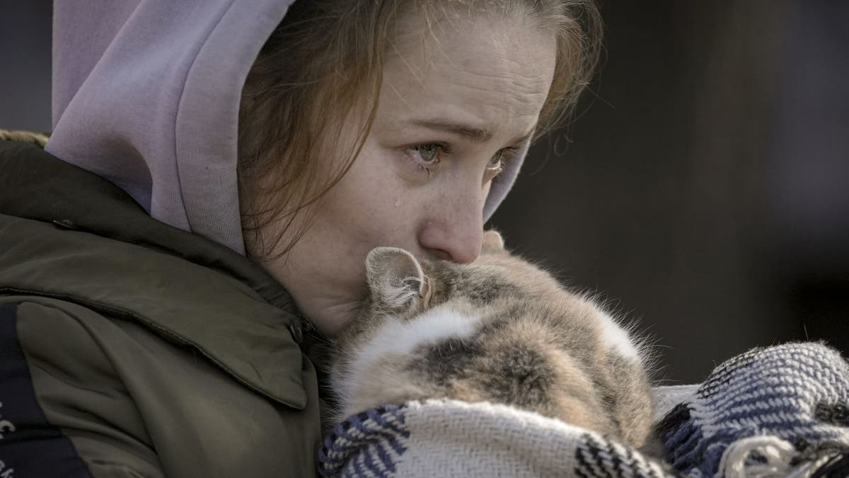 Woman cries while holding cat