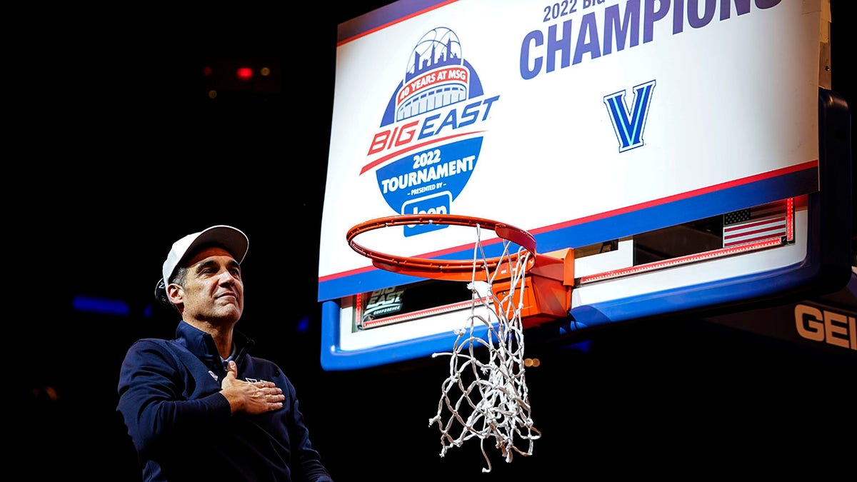 Villanova head coach Jay Wright gestures to supporters while cutting down the net after the final of the Big East conference tournament against Creighton, Saturday, March 12, 2022, in New York.