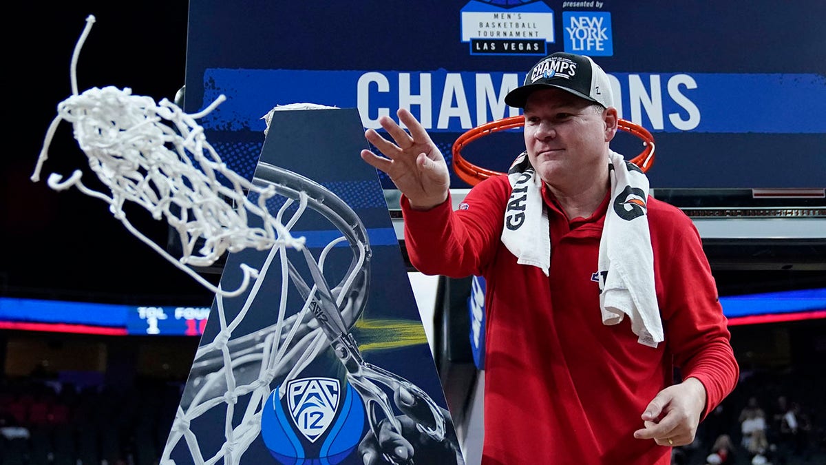 Arizona head coach Tommy Lloyd cuts down the net after defeating UCLA in an NCAA college basketball game in the championship of the Pac-12 tournament Saturday, March 12, 2022, in Las Vegas.