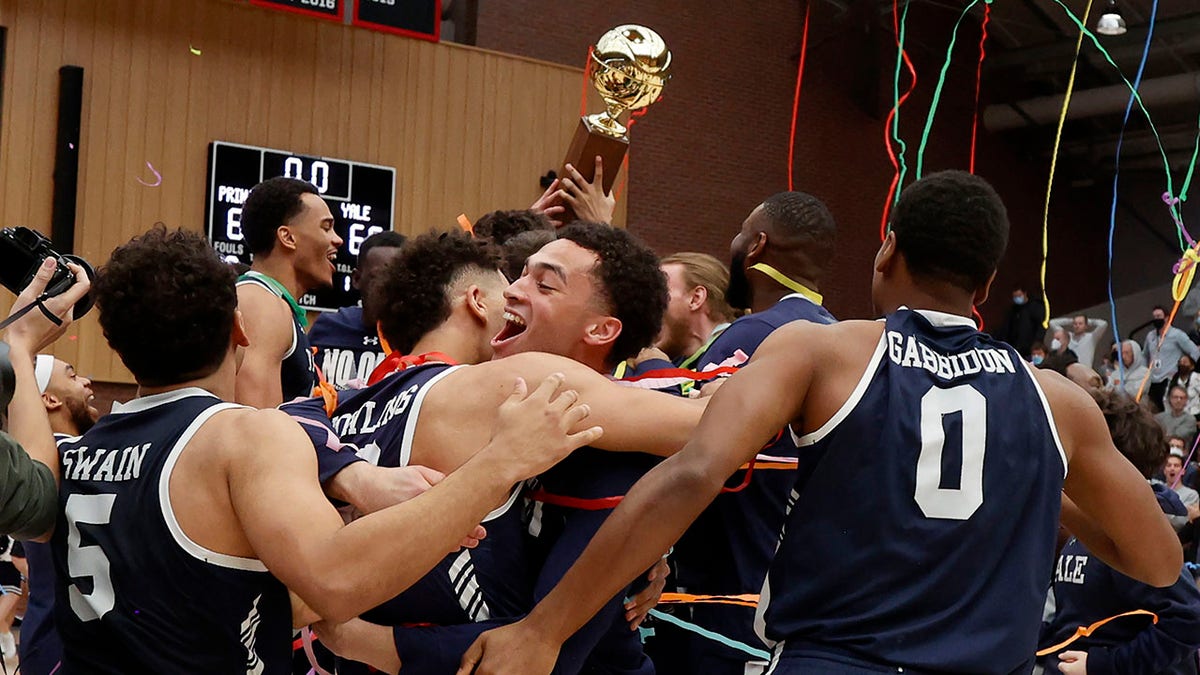 Yale players celebrate after defeating Princeton in the NCAA Ivy League men's college basketball championship game, Sunday, March 13, 2022, in Cambridge, Mass.