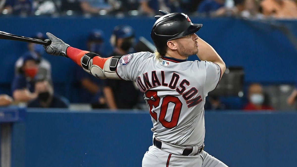 FILE - Minnesota Twins' Josh Donaldson follows through on a solo home run against the Toronto Blue Jays during the third inning of a baseball game Sept. 17, 2021, in Toronto. The New York Yankees have acquired former AL MVP Donaldson and shortstop Isiah Kiner-Falefa from the Twins for catcher Gary Sanchez and third baseman Gio Urshela.