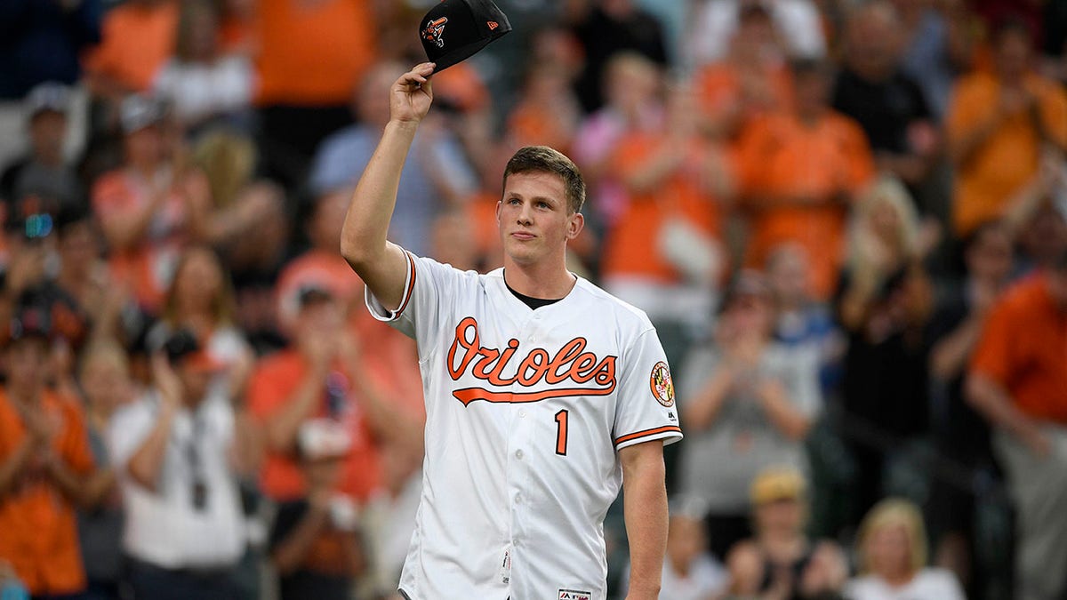 FILE - Baltimore Orioles first-round draft pick Adley Rutschman tips his cap to the crowd as he was introduced between innings of a baseball game against the San Diego Padres, Tuesday, June 25, 2019, in Baltimore. Orioles catcher Adley Rutschman, Kansas City Royals shortstop Bobby Witt Jr. and Detroit Tigers infielder Spencer Torkelson are among baseball's most intriguing rookies this summer.