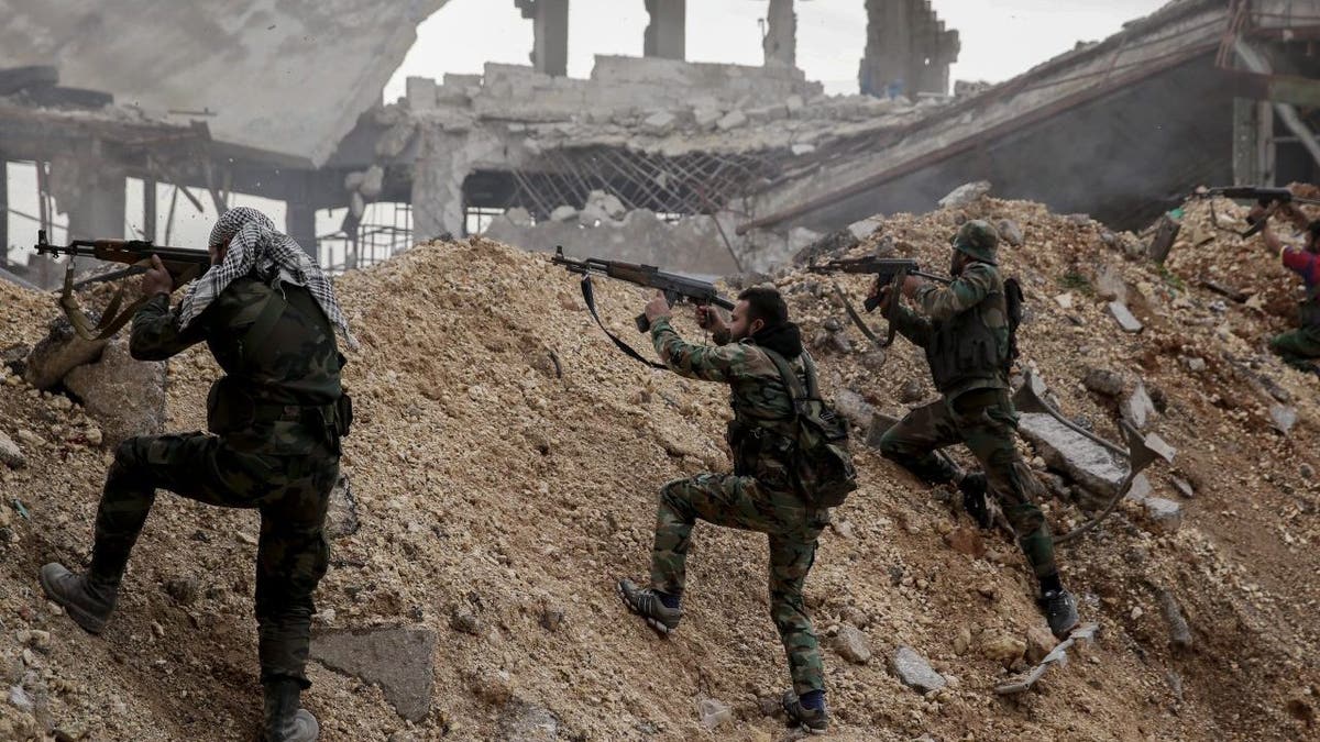 FILE - Syrian army soldiers fire their weapons during a battle with rebel fighters at the Ramouseh front line, east of Aleppo, Syria, Monday, Dec. 5, 2016.?