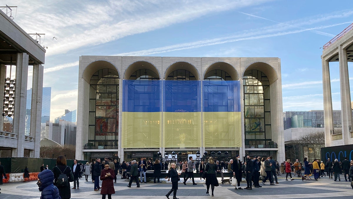 Ukraine's flag is draped outside The Metropolitan Opera House at Lincoln Center for the Performing Arts in New York before a benefit for Ukraine concert, Monday, March 14, 2022.