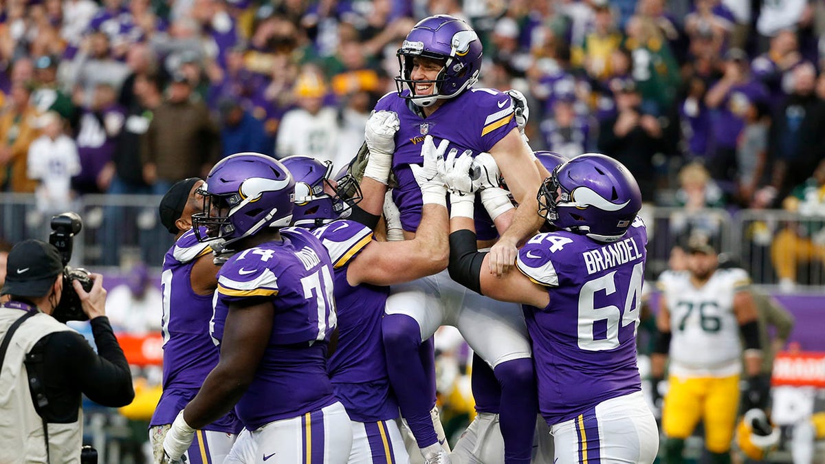 FILE - Minnesota Vikings kicker Greg Joseph, center, celebrates with teammates after kicking a 29-yard field goal on the final play of an NFL football game against the Green Bay Packers, Sunday, Nov. 21, 2021, in Minneapolis. The Vikings won 34-31. In a deal announced Monday, March 14, 2022, the Vikings tendered a contract offer to restricted free agent kicker Joseph.
