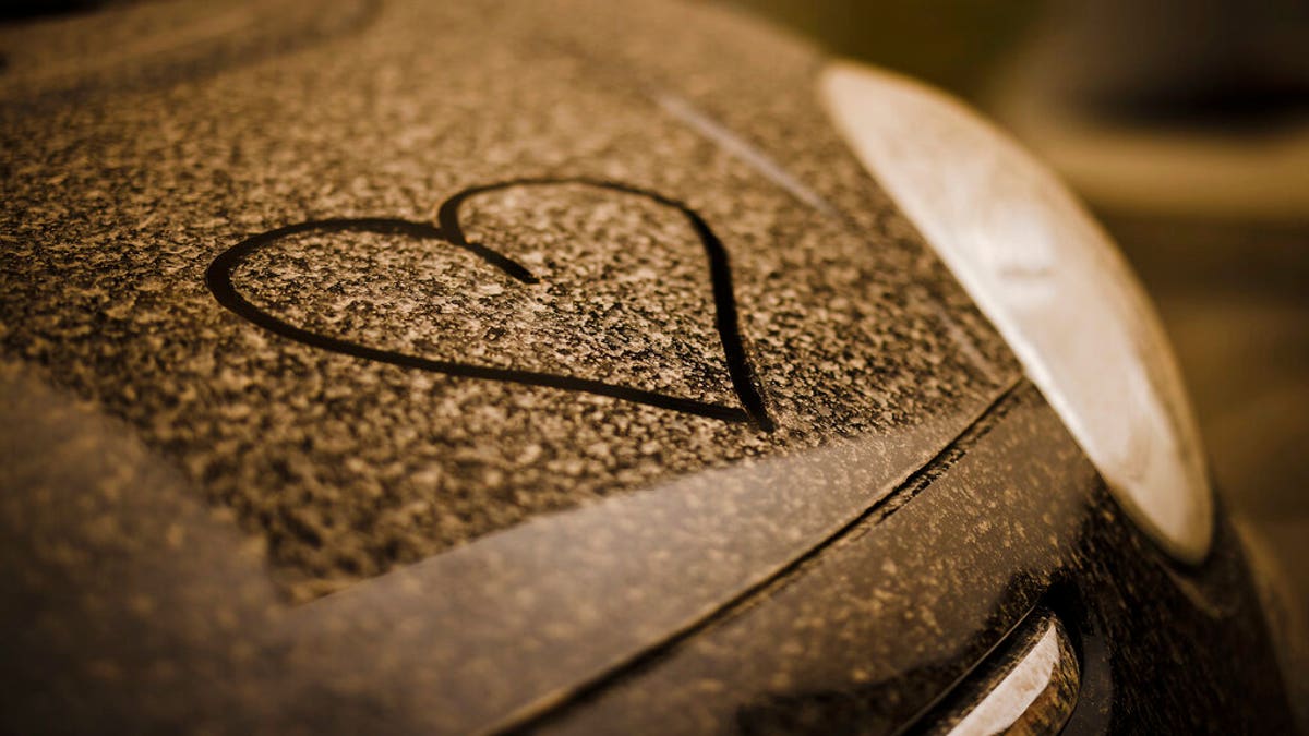 A drawn heart is seen on a black painted car covered with sahara dust, in Zurich, Switzerland.
