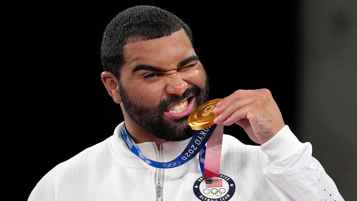 FILE - In this Aug. 6, 2021, file photo, United State's Gable Dan Steveson poses with his gold medal during the medal ceremony for the men's freestyle 125kg wrestling at the 2020 Summer Olympics, in Chiba, Japan. Gable Steveson knew his life had changed after he won an Olympic gold medal in wrestling. But the University of Minnesota star remains shocked by how fans have celebrated him this season during what has amounted to a college farewell tour.