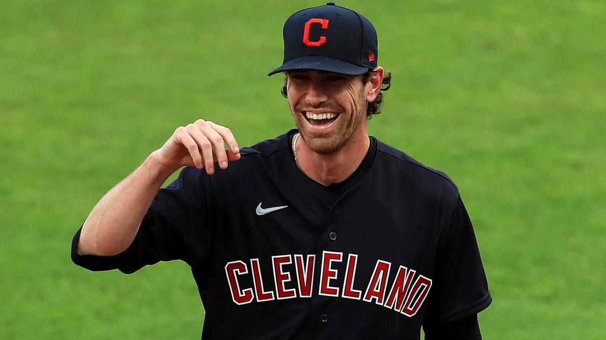 FILE - Cleveland Indians' Shane Bieber (57) reacts between innings during a baseball game against the Cincinnati Reds in Cincinnati, on Aug. 4, 2020. The 2020 Cy Young winner, who was limited to just 16 starts last season due to a right shoulder strain, said Tuesday, March 15, 2022, that he remains open to signing a long-term contract extension with Cleveland.