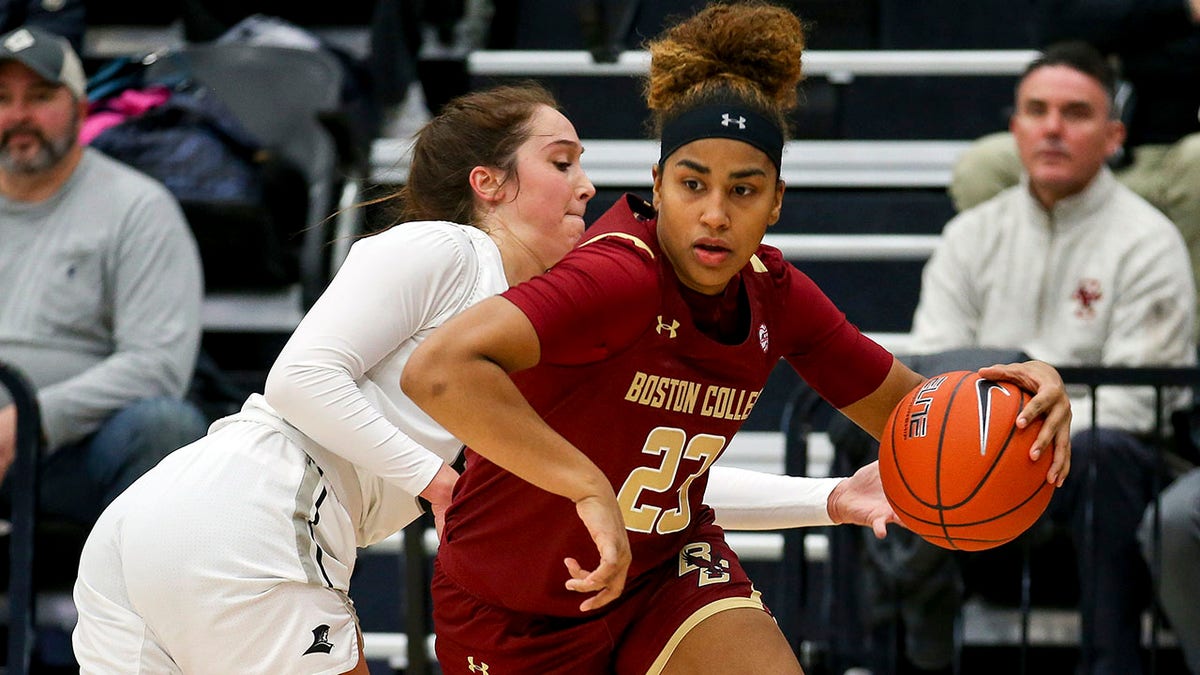 FILE - Boston College's Milan Bolden-Morris (23) avoids a steal attempt by Providence's Kyra Spiwak (5) during an NCAA women's basketball game on Nov. 17, 2019 in Providence, R.I. Bolden-Morris will be the first woman to become a football graduate assistant coach for a Power Five football program and in the Big Ten. Michigan announced her hire Tuesday, March 15, 2022. Bolden-Morris is a Florida native who played three seasons at Boston College before transferring as a graduate student to Georgetown.
