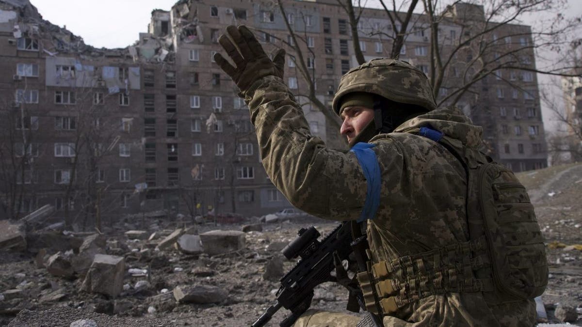 A Ukrainian serviceman guards his position in Mariupol, Ukraine, Saturday, March 12, 2022. 