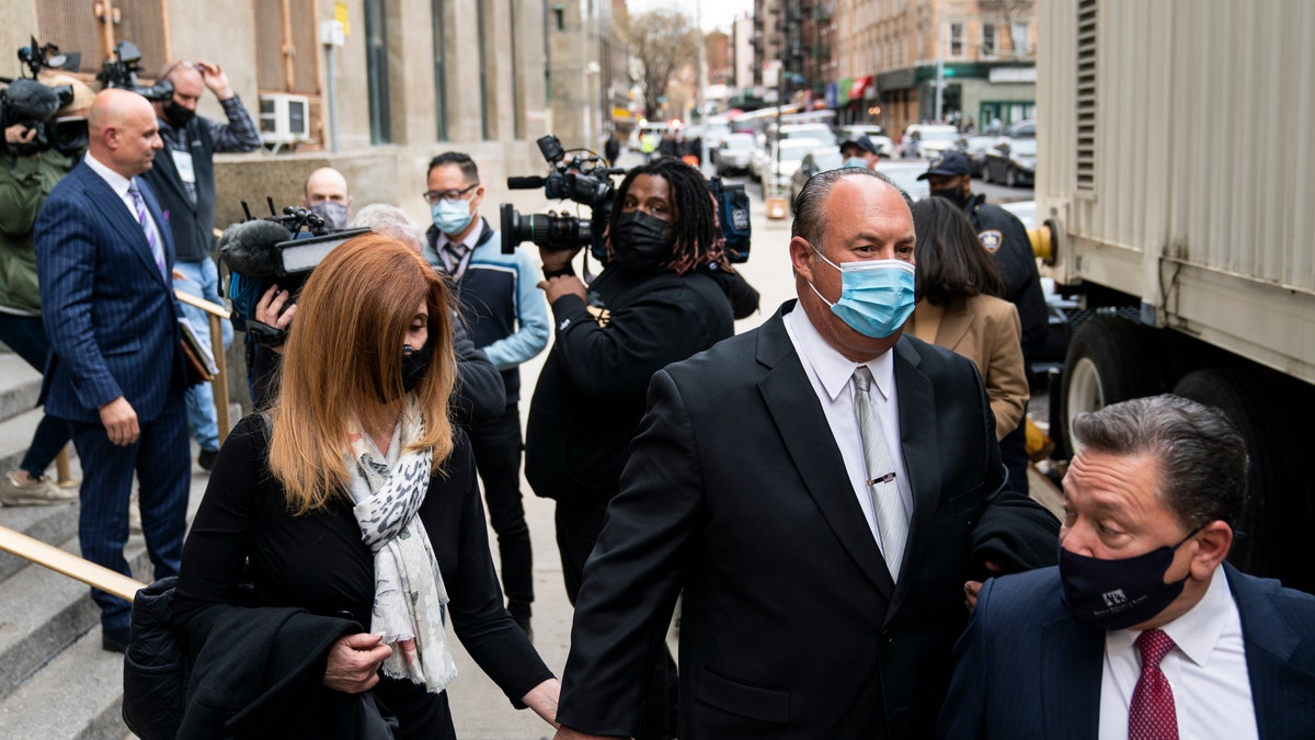 The parents of Lauren Pazienza leave criminal court trailed by members of the media after their daughter's arraignment , Tuesday, March 22, 2022, in New York. The 26-year-old woman of Port Jefferson, Long Island, faces a manslaughter charge in the death of Barbara Maier Gustern. Pazienza was arrested Tuesday in the death of a 87-year-old Broadway singing coach who was shoved to the ground on a New York City street.