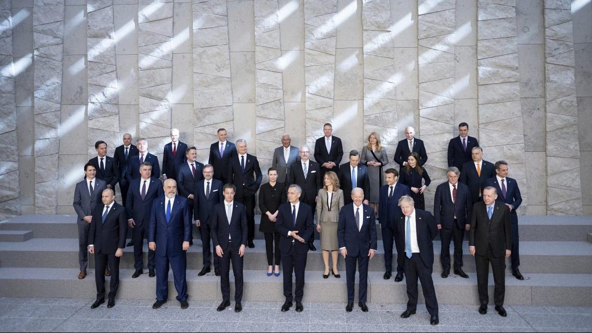 First row from right, Turkey's President Recep Tayyip Erdogan, Britain's Prime Minister Boris Johnson, U.S. President Biden, NATO Secretary General Jens Stoltenberg, Belgium's Prime Minister Alexander De Croo and leaders of the US-led military alliance pose for a family photo at NATO Headquarters in Brussels, Thursday, March 24, 2022. 