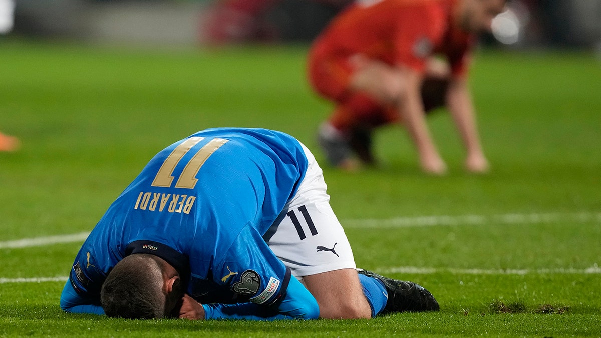 Italy's Domenico Berardi knees after missing a scoring chance during the World Cup qualifying play-off soccer match between Italy and North Macedonia, at Renzo Barbera stadium, in Palermo, Italy, Thursday, March 24, 2022.