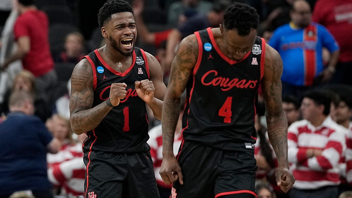 Houston guard Taze Moore, right, celebrates their win against Arizona with guard Jamal Shead during the second half of a college basketball game in the Sweet 16 round of the NCAA tournament on Thursday, March 24, 2022, in San Antonio.