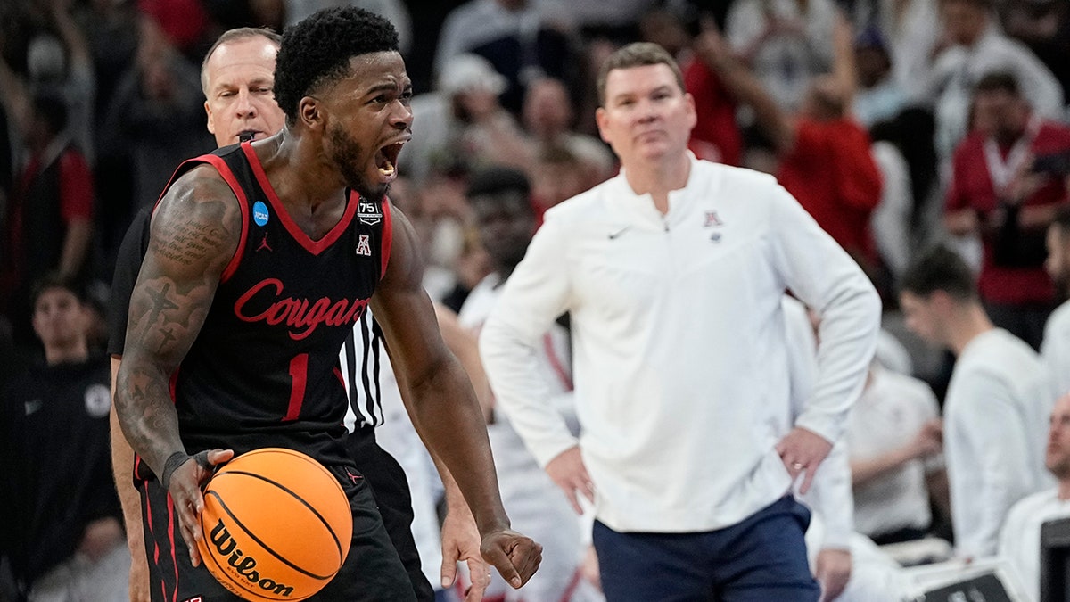 Houston guard Jamal Shead celebrates after scoring as Arizona head coach Tommy Lloyd looks on during the second half of a college basketball game in the Sweet 16 round of the NCAA tournament on Thursday, March 24, 2022, in San Antonio.