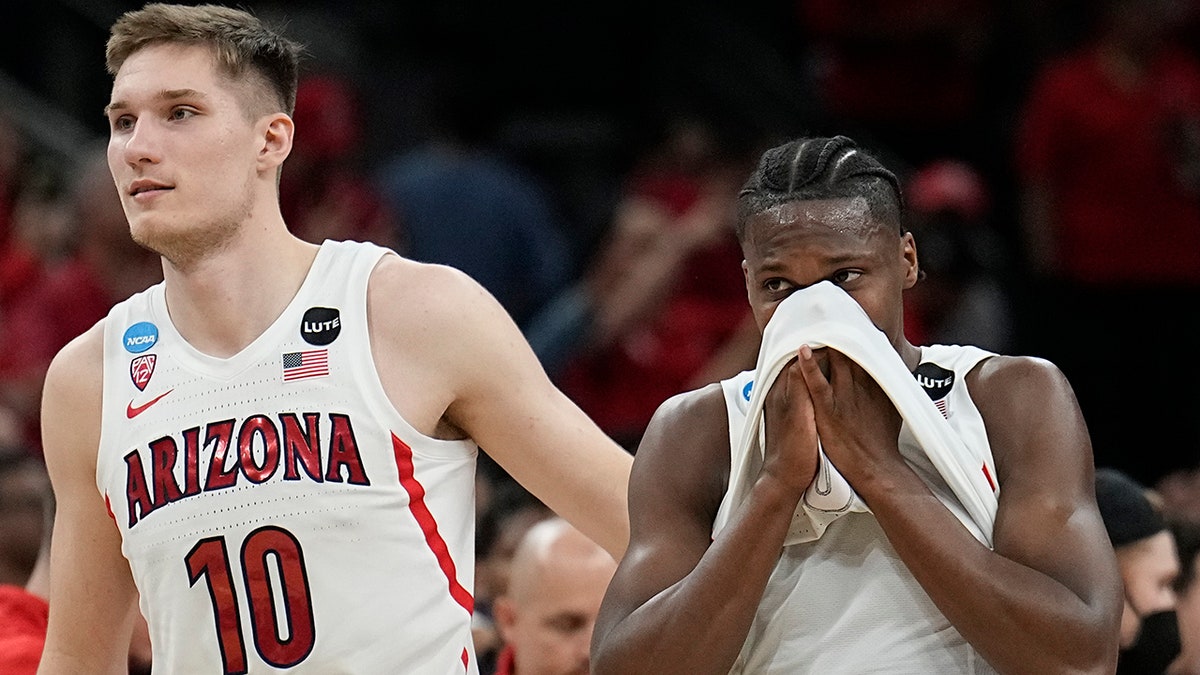 Arizona forward Azuolas Tubelis and guard Bennedict Mathurin leave the court after their loss to Houston in a college basketball game in the Sweet 16 round of the NCAA tournament on Thursday, March 24, 2022, in San Antonio.