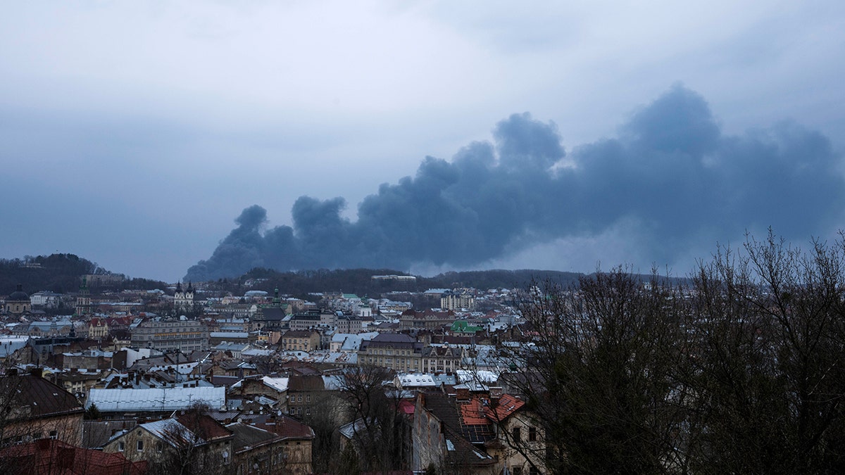 Smoke rises in the sky in Lviv, western Ukraine, Saturday, March 26, 2022. (AP Photo/Nariman El-Mofty)