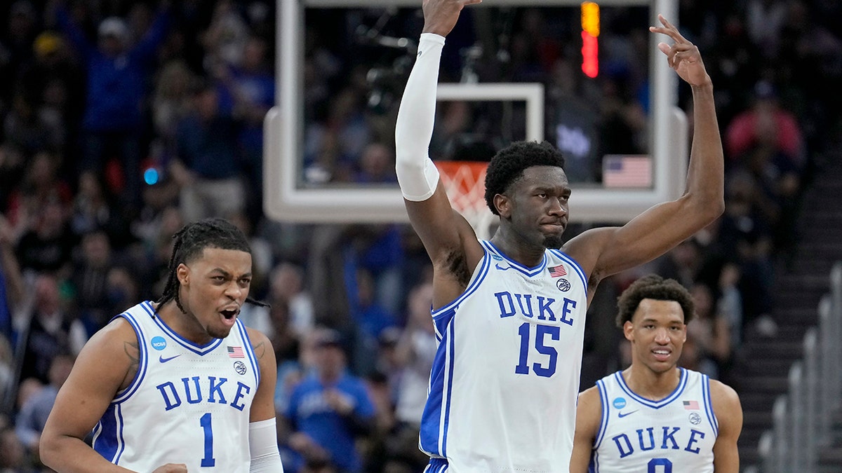 Duke guard Trevor Keels (1) celebrates with center Mark Williams (15) and forward Wendell Moore Jr. (0) during the second half of a college basketball game against Arkansas in the Elite 8 round of the NCAA men's tournament in San Francisco, Saturday, March 26, 2022. (AP Photo/Tony Avelar)