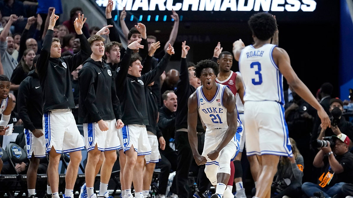 Duke forward AJ Griffin (21) celebrates in front of teammates on the bench after shooting a three point basket against Arkansas during the second half of a college basketball game in the Elite 8 round of the NCAA men's tournament in San Francisco, Saturday, March 26, 2022. (AP Photo/Marcio Jose Sanchez)