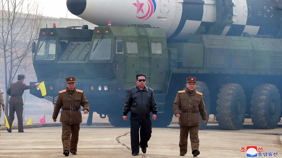 In this photo distributed by the North Korean government, North Korean leader Kim Jong Un, center, walks around what it says a Hwasong-17 intercontinental ballistic missile (ICBM) on the launcher, at an undisclosed location in North Korea on March 24, 2022.