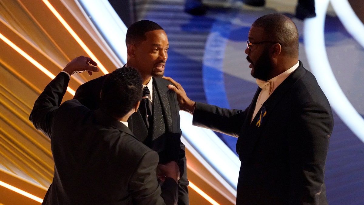 Sean Combs, from left, Will Smith and Tyler Perry appear in the audience at the Oscars on Sunday, March 27, 2022, at the Dolby Theatre in Los Angeles. (AP Photo/Chris Pizzello)