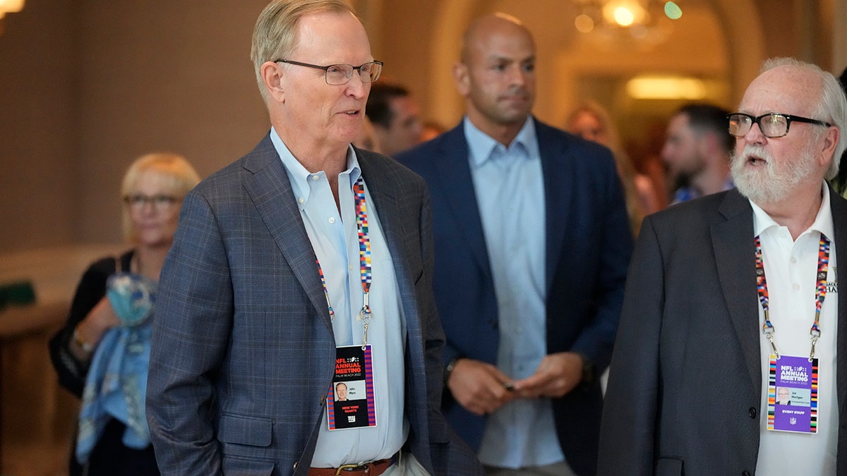 New York Giants co-owner, president and CEO John Mara, front left, arrives for a presentation at the start of the NFL football owners meeting, Sunday, March 27, 2022, at The Breakers resort in Palm Beach, Fla.