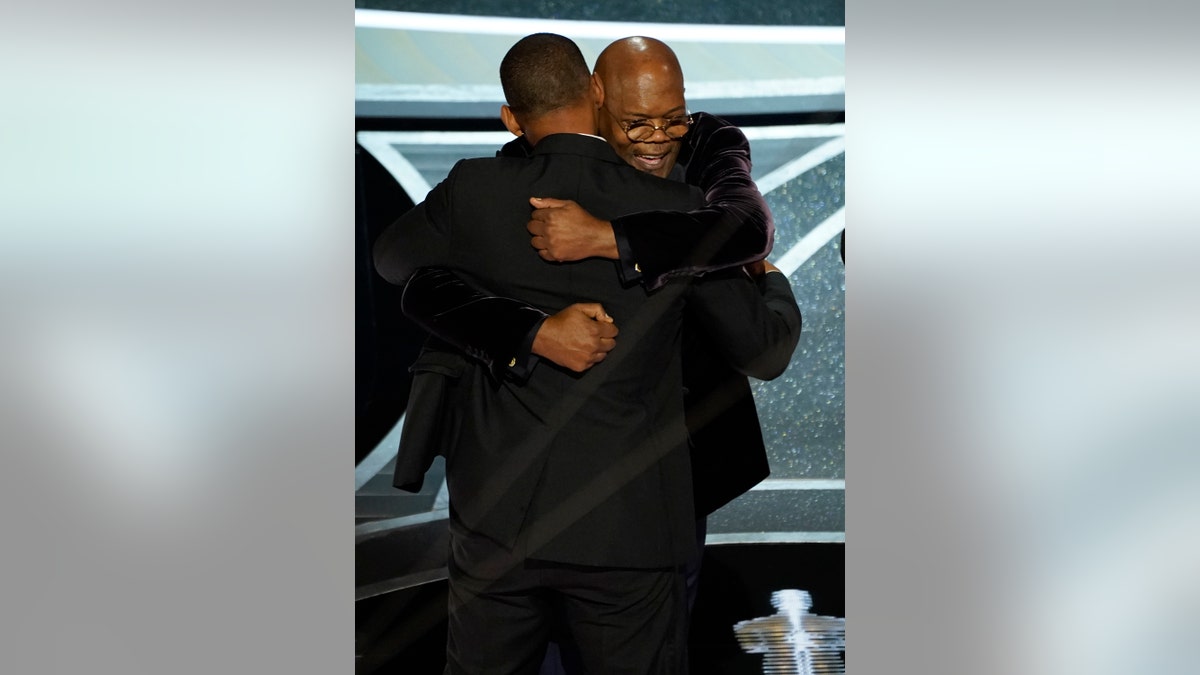 Will Smith and Samuel L. Jackson hug in the audience as Will Smith is announced the winner of the award for best performance by an actor in a leading role for "King Richard" at the Oscars on Sunday, March 27, 2022. (AP Photo/Chris Pizzello)