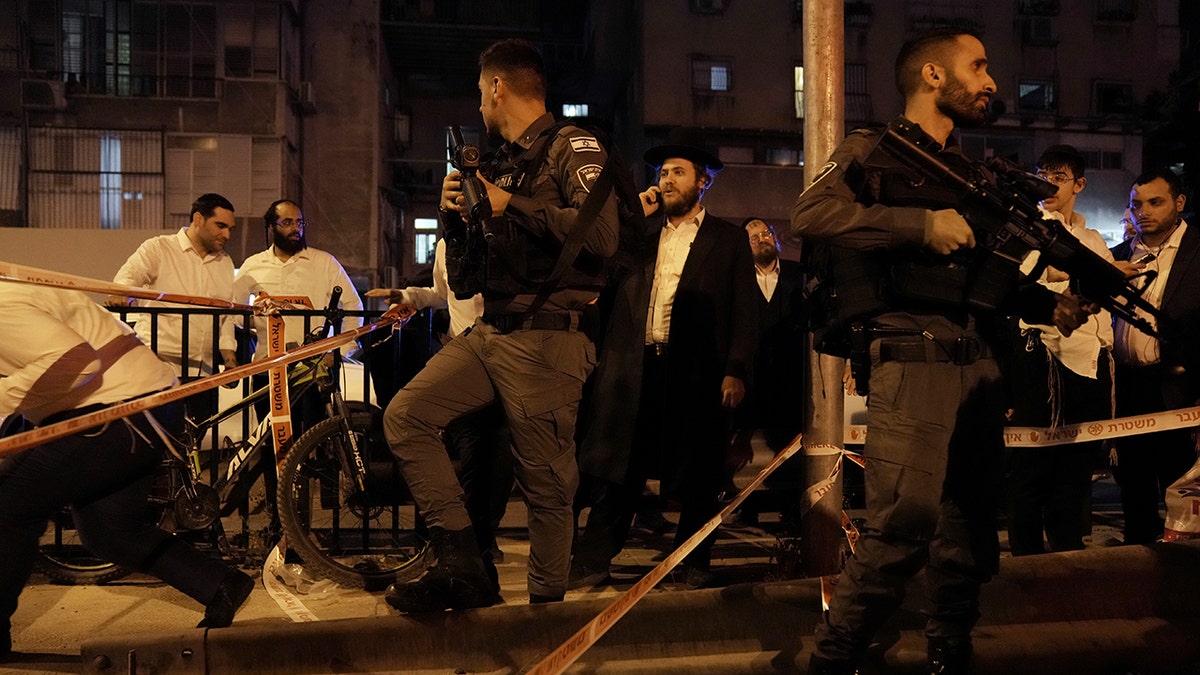 Police secure the site where a gunman opened fire in Bnei Brak, Israel, Tuesday, March 29, 2022.