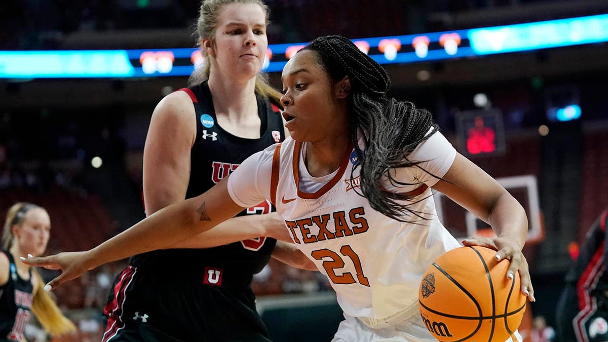 Texas forward Aaliyah Moore (21) drives around Utah forward Kelsey Rees, left, during the second half of a college basketball game in the second round of the NCAA women's tournament, Sunday, March 20, 2022, in Austin, Texas.