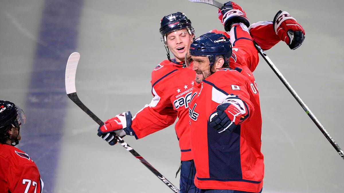 Washington Capitals left wing Alex Ovechkin (8) celebrates his goal with defenseman John Carlson (74) and right wing T.J. Oshie (77) during the third period of an NHL hockey game against the Seattle Kraken, Saturday, March 5, 2022, in Washington.