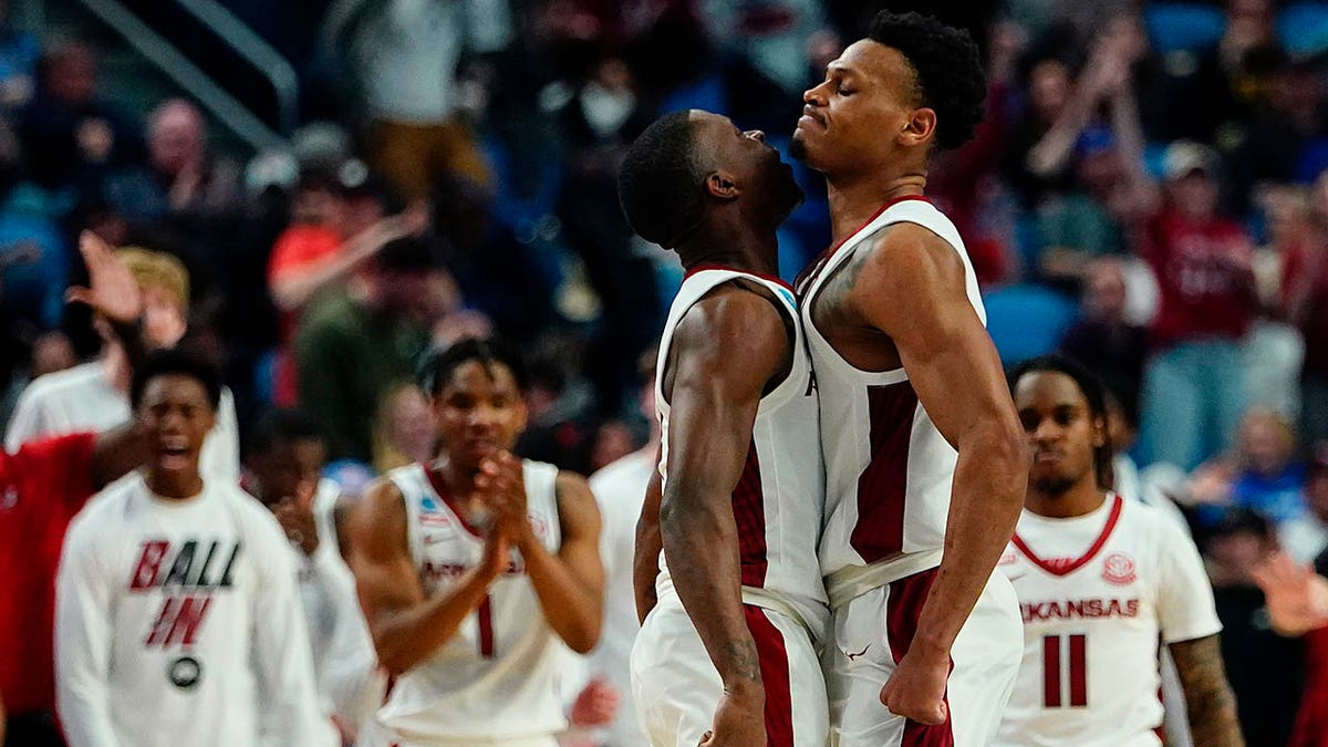 Arkansas guard Davonte Davis, left, and guard Au'Diese Toney celebrate during the second half of the team's college basketball game against New Mexico State in the second round of the NCAA men's tournament Saturday, March 19, 2022, in Buffalo, N.Y. 