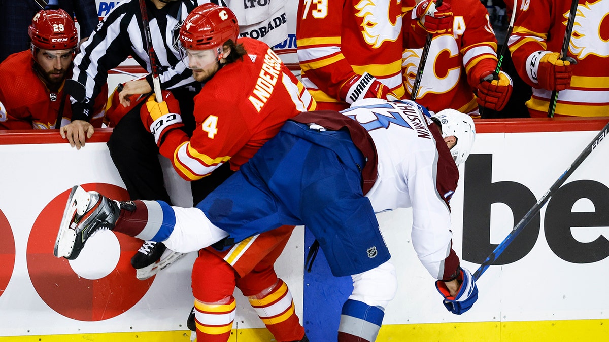 Colorado Avalanche right wing Valeri Nichushkin (13) checks Calgary Flames' Rasmus Andersson during the second period of an NHL hockey game Tuesday, March 29, 2022 in Calgary, Alberta.