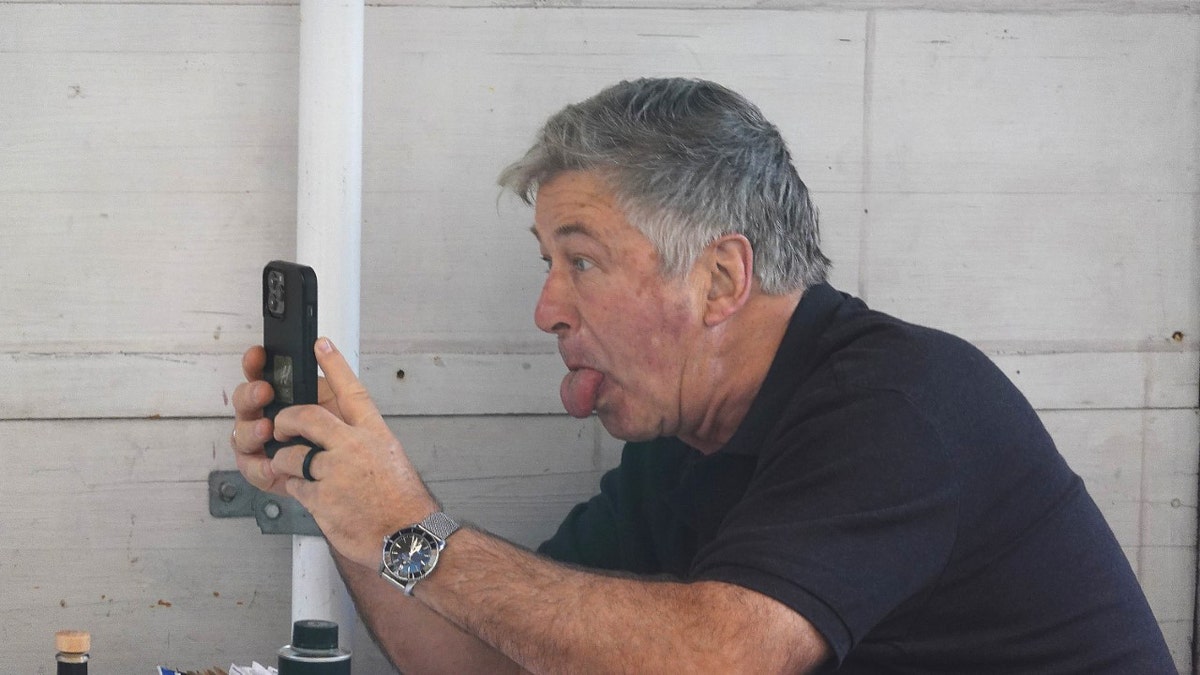 Alec Baldwin displays a silly face as he appears to be video chatting with his children from Rome.