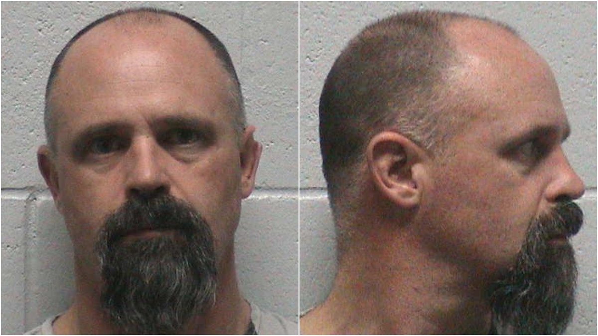 Troy Driver appears in mugshots with a beard