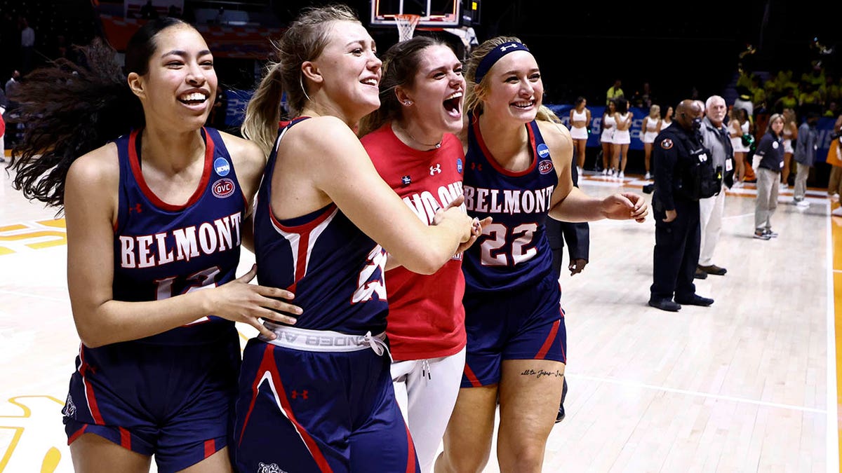 Belmont guard Kilyn McGuff (12), guard Nikki Baird (23) and forward Tessa Miller (22) celebrate with a teammate after a double-overtime win in a college basketball game against Oregon in the first round of the NCAA tournament, Saturday, March 19, 2022, in Knoxville, Tenn.
