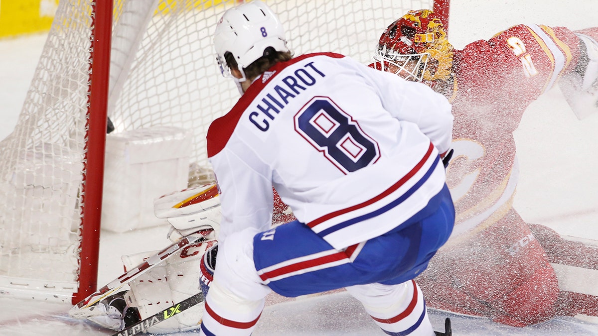 Montreal Canadiens defenseman Ben Chiarot scores in overtime against Calgary Flames goalie Jacob Markstron during an NHL hockey game Thursday, March 3, 2022, in Calgary, Alberta.