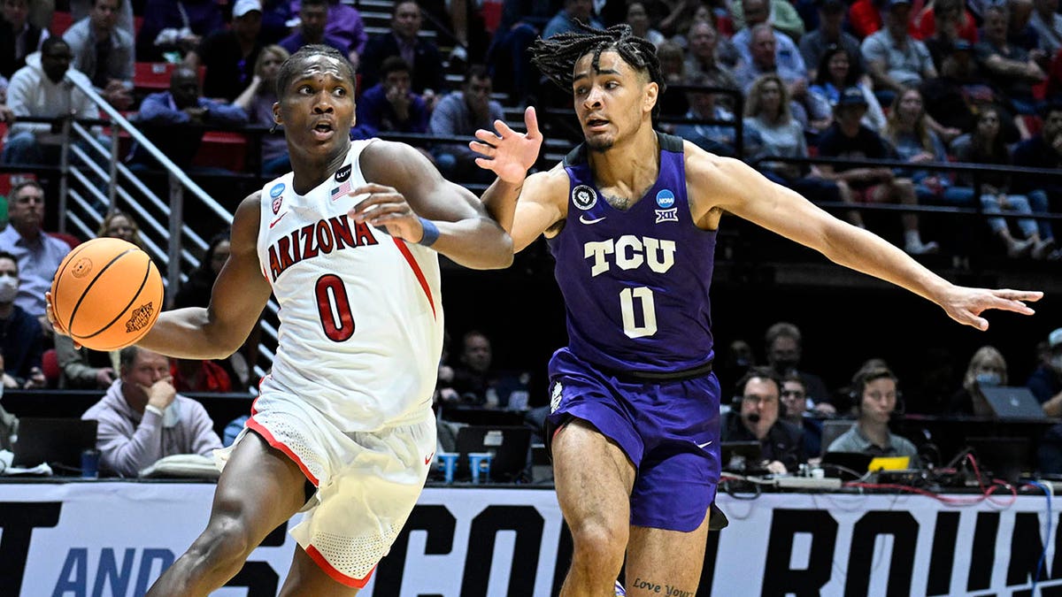 Arizona guard Bennedict Mathurin, left, drives around TCU guard Micah Peavy, right, during the first half of a second-round NCAA college basketball tournament game, Sunday, March 20, 2022, in San Diego.