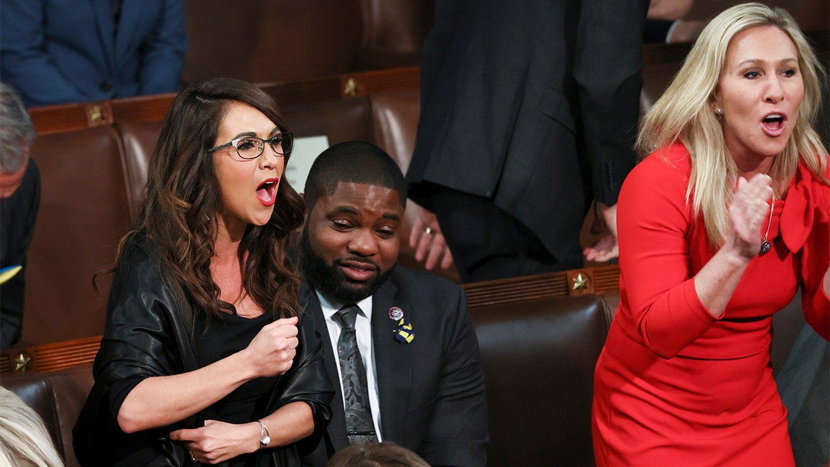 Rep. Lauren Boebert, R-Colo., left, and Rep. Marjorie Taylor Greene, R-Ga., right, scream "Build the Wall" as President Biden delivers his first State of the Union address to a joint session of Congress at the Capitol, Tuesday, March 1, 2022, in Washington. 