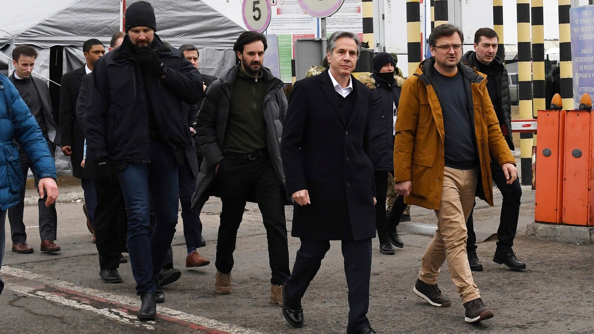 U.S. Secretary of State Antony Blinken, center, and Ukrainian Foreign Minister Dmytro Kuleba, second right, walk together after meeting at the Ukrainian-Polish border crossing in Korczowa, Poland, Saturday, March 5, 2022.