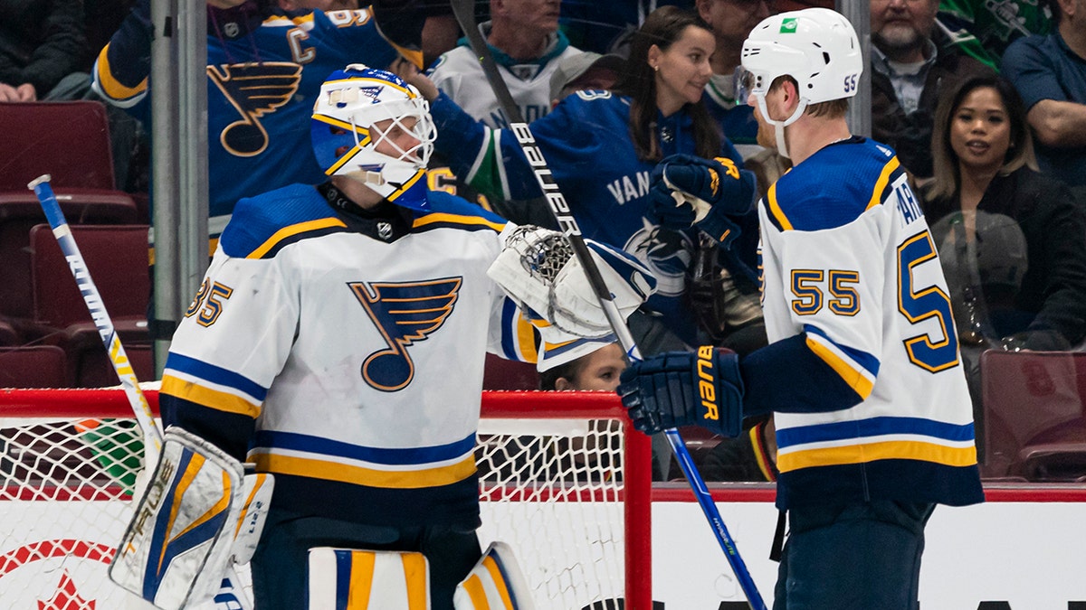 St. Louis Blues' goalie Ville Husso (35) is celebrates with Colton Parayko after the Blues defeated the Vancouver Canucks 4-3 in an NHL hockey game Wednesday, March 30, 2022, in Vancouver, British Columbia.