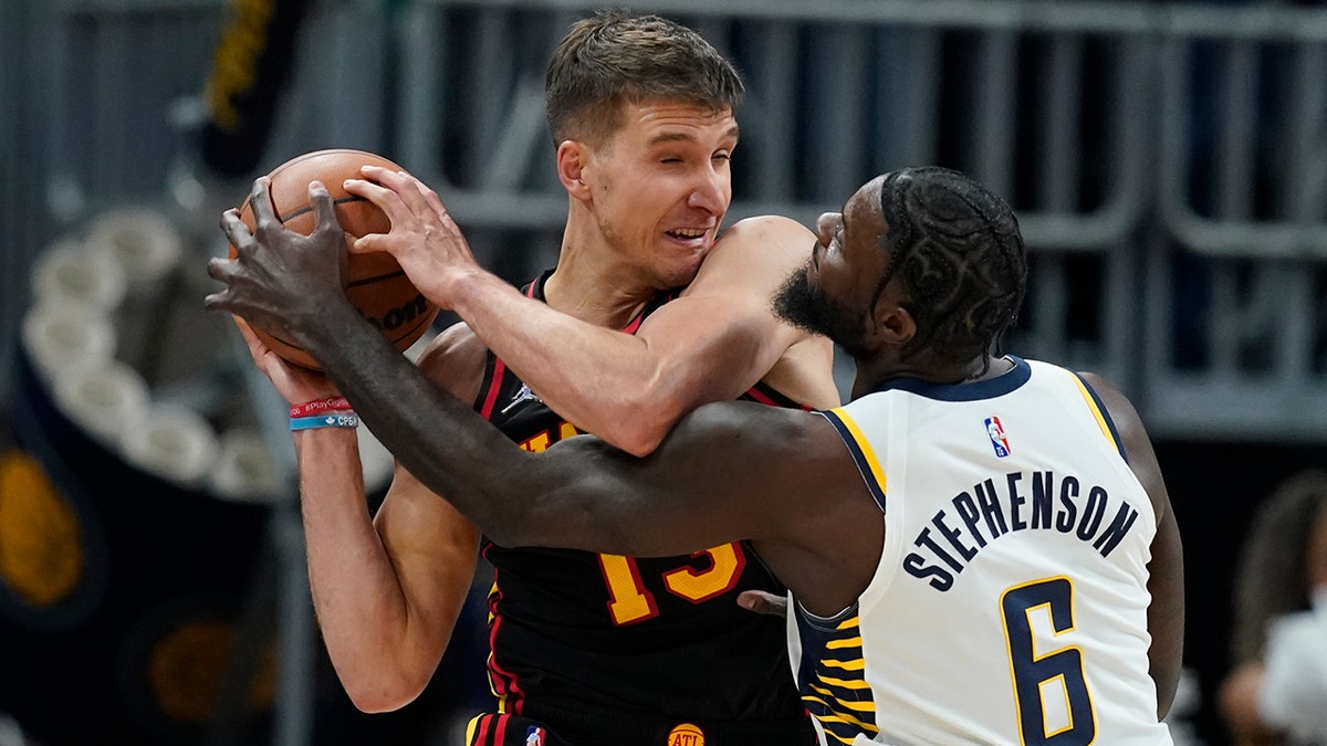 Atlanta Hawks' Bogdan Bogdanovic is defended by Indiana Pacers' Lance Stephenson during the second half of an NBA basketball game, Monday, March 28, 2022, in Indianapolis.
