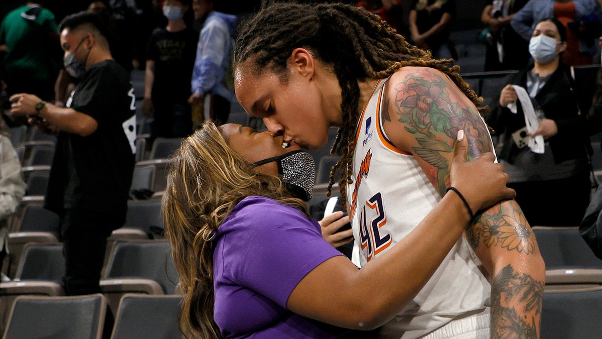 Brittney Griner of the Phoenix Mercury kisses her wife, Cherelle Griner