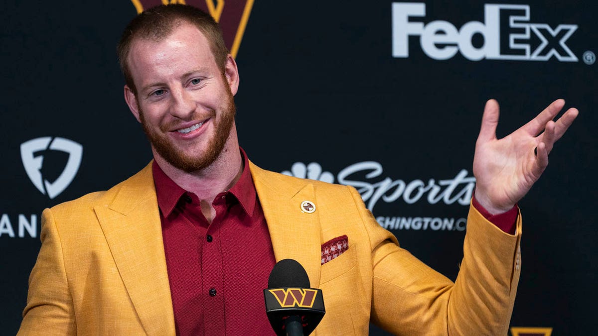 Washington Commanders NFL football team new quarterback Carson Wentz greets members of the media after being introduced by head coach Ron Rivera, a during a news conference in Ashburn, Va., Thursday, March 17, 2022.
