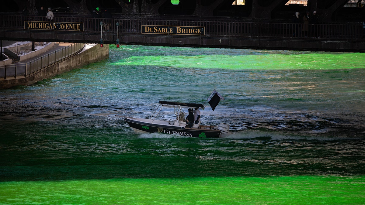 A boat sailed through the Chicago River after it was dyed green on Saturday, March 12, 2022.