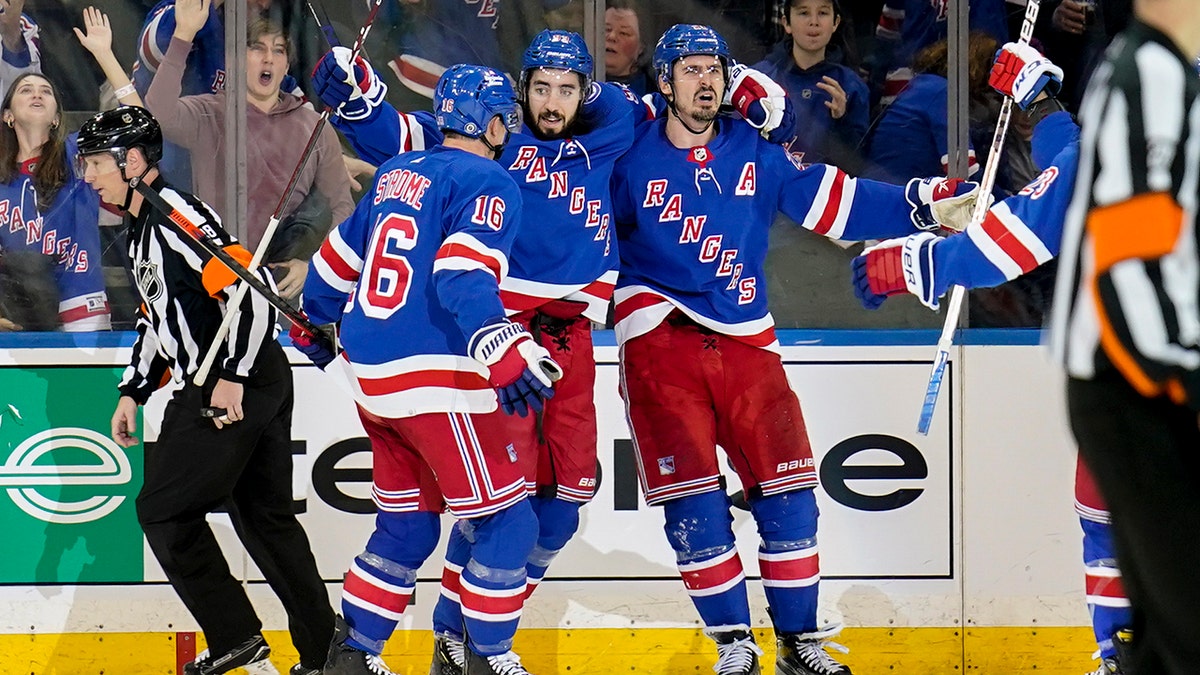 New York Rangers left wing Chris Kreider, center right, celebrates after scoring the go-ahead goal on St. Louis Blues goaltender Ville Husso (35) during the third period of an NHL hockey game, Wednesday, March 2, 2022, in New York.