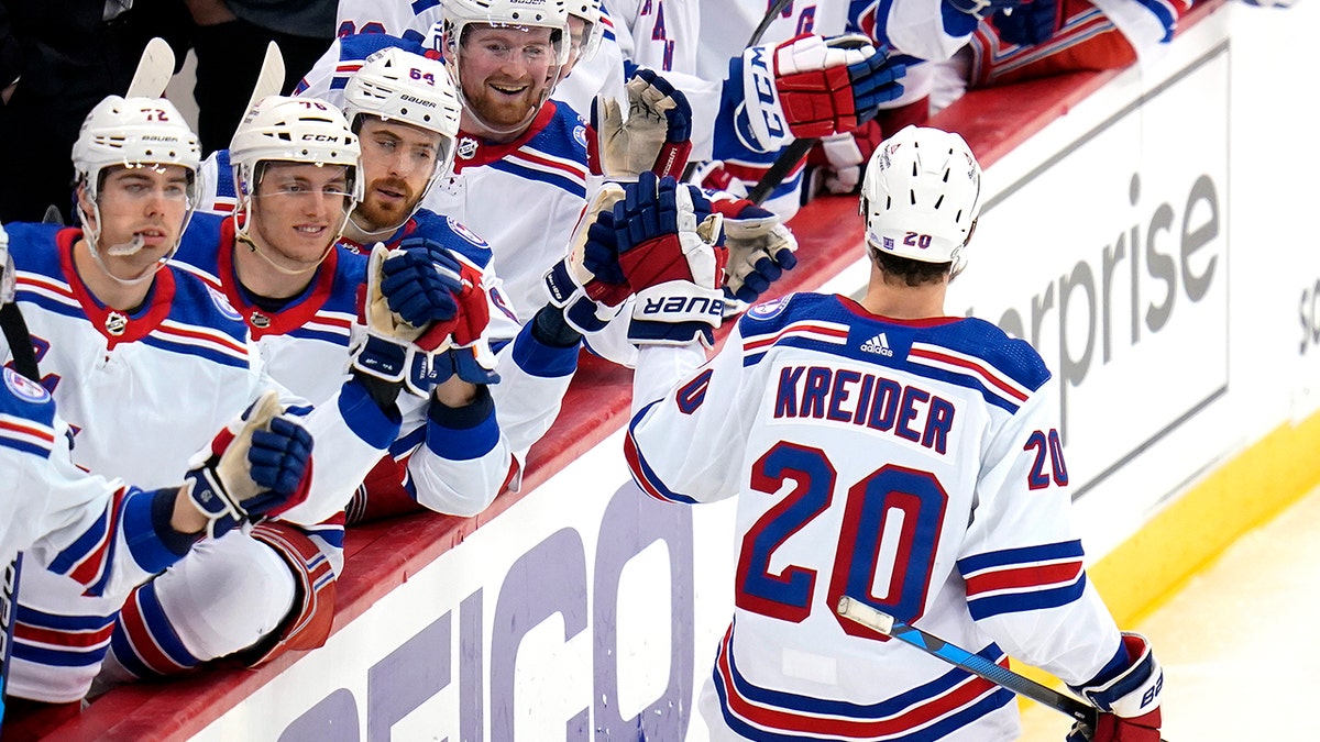 New York Rangers' Chris Kreider (20) returns to the bench after scoring during the third period of an NHL hockey game against the Pittsburgh Penguins in Pittsburgh, Tuesday, March 29, 2022. The Rangers won 3-2.